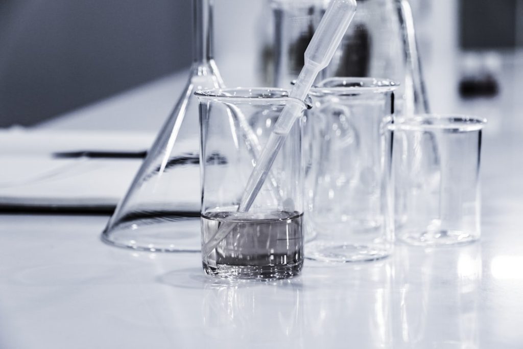 three-clear-beakers-placed-on-tabletop-lqgjcmy5qcm